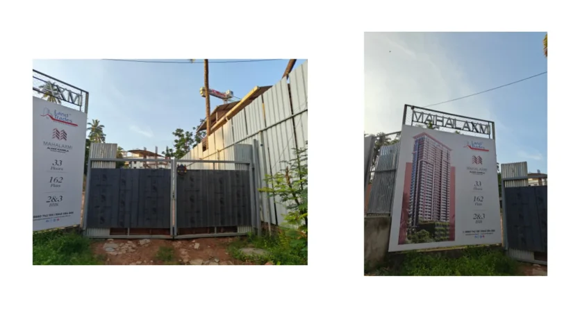 Real photograph of the Land Traders Mahalaxmi Project compound gate and tower elevation poster showing project details.